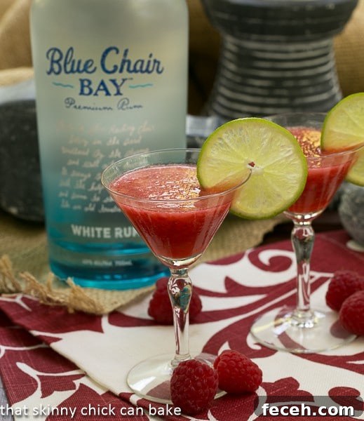 Frozen Fresh Berry Daiquiris in front of a bottle of rum