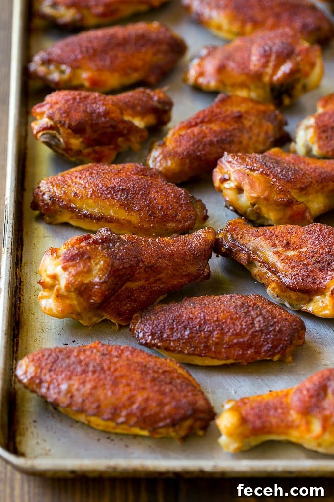 Smoked chicken wings coated in spice rub on a sheet pan.