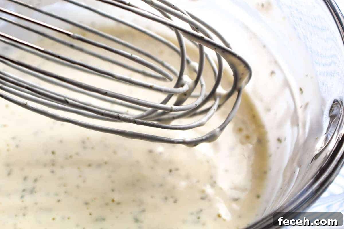 Whisk in bowl coated with dressing.