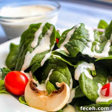 Buttermilk Dill Ranch Dressing on spinach greens with cherry tomatoes and mushroom slices