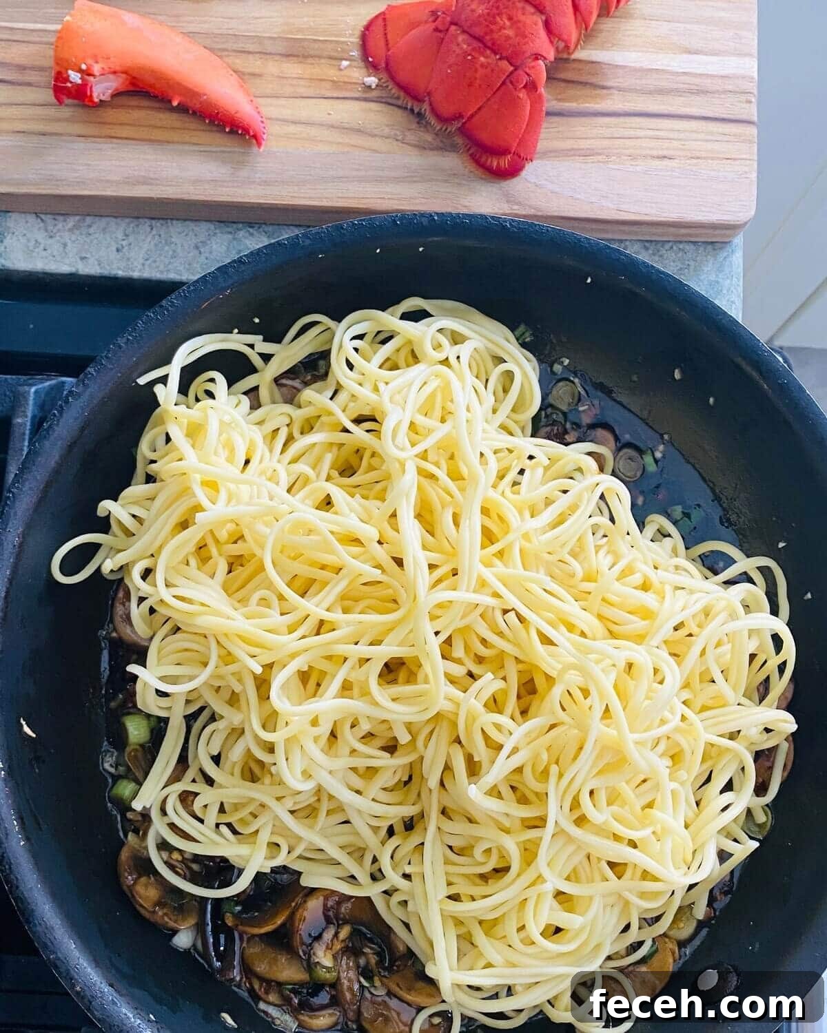Add noodles to lobster stir fry.