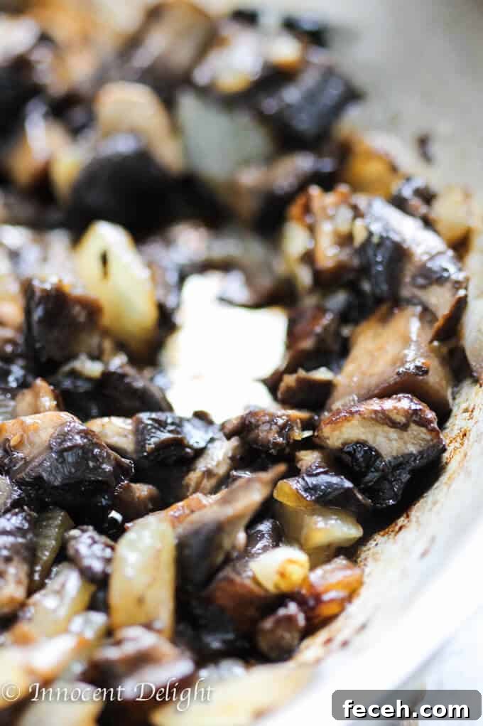 Sautéed portabello mushrooms with onions on a pan