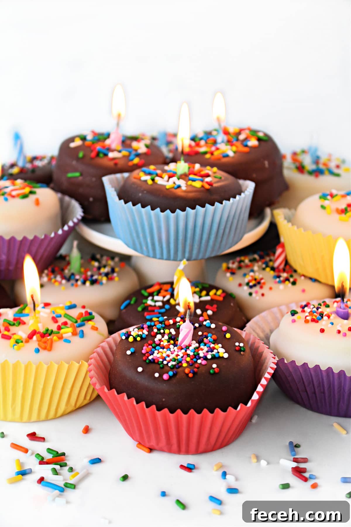Birthday Cake Cookie Recipe: Soft, Sprinkle-Stuffed Treats 2 Birthday Cake Cookies topped with chocolate glaze, sprinkles and a lit candle.