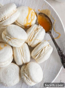 plate with caramel macarons and a spoonful of salted caramel on the plate too.