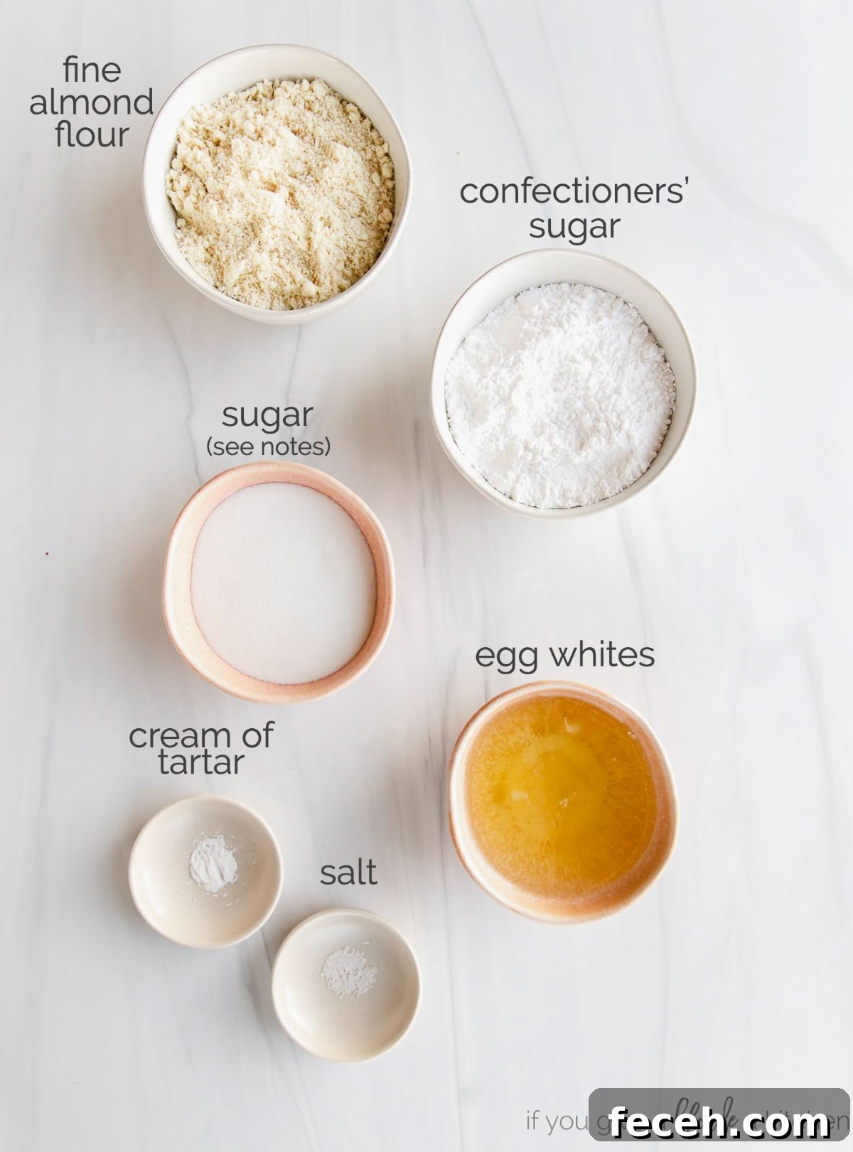 french macaron ingredients in bowls labeled with text