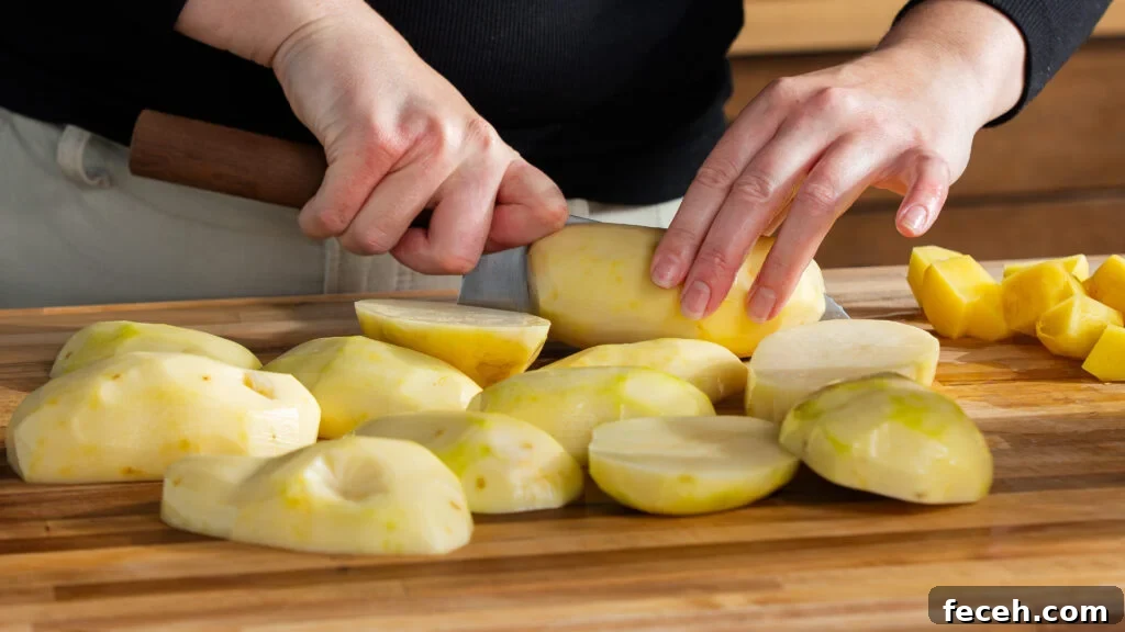 Slicing potatoes to make an easy mashed potatoes recipe.
