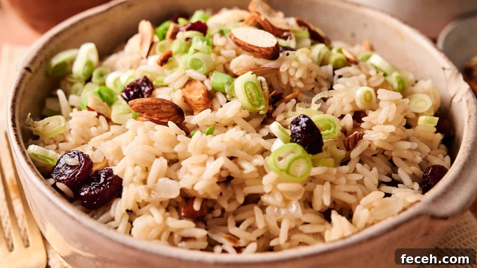 31 Asian Weeknight Dinners to Make Mealtime Exciting 14 A bowl of rice pilaf topped with sliced green onions, almonds, and dried cranberries.