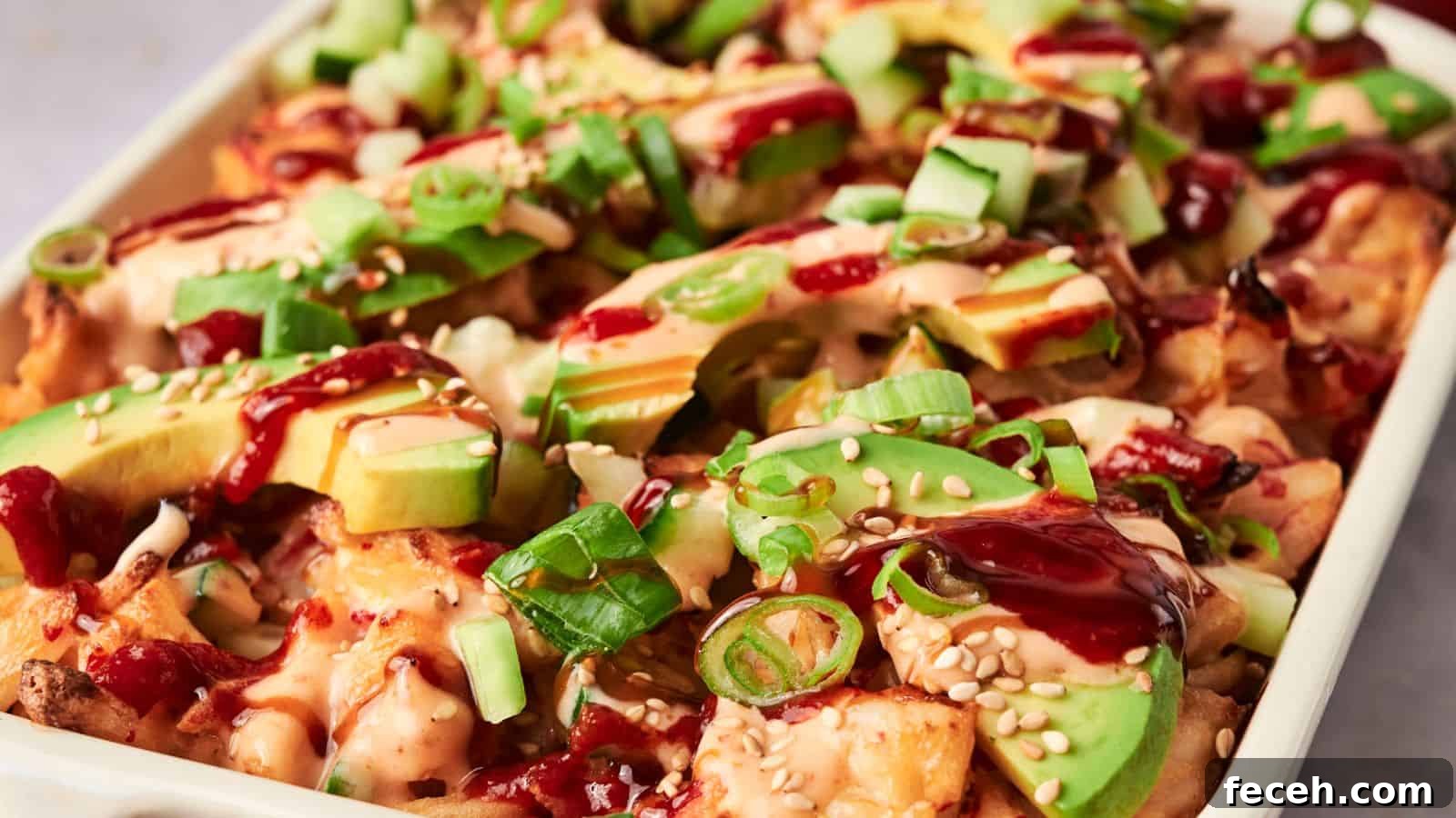 31 Asian Weeknight Dinners to Make Mealtime Exciting 30 A dish of loaded fries inspired by sushi bake, topped with avocado slices, diced cucumbers, green onions, sesame seeds, and drizzled with sauce.