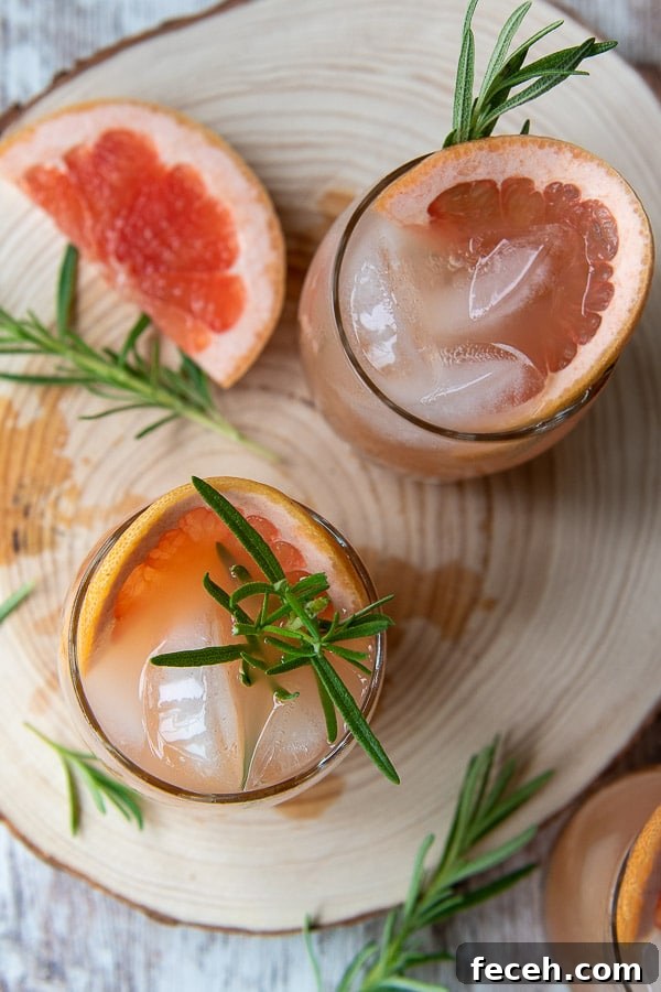 overhead shot of grapefruit cocktails on a wooden board