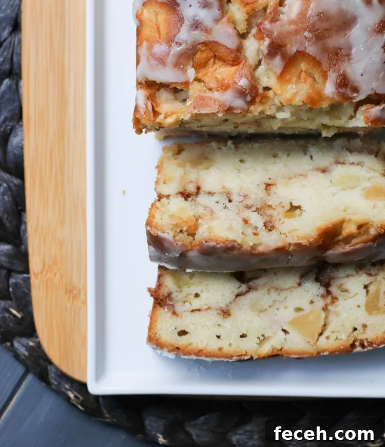 Top view of a loaf of Apple Fritter Bread with 2 slices cut and facing up