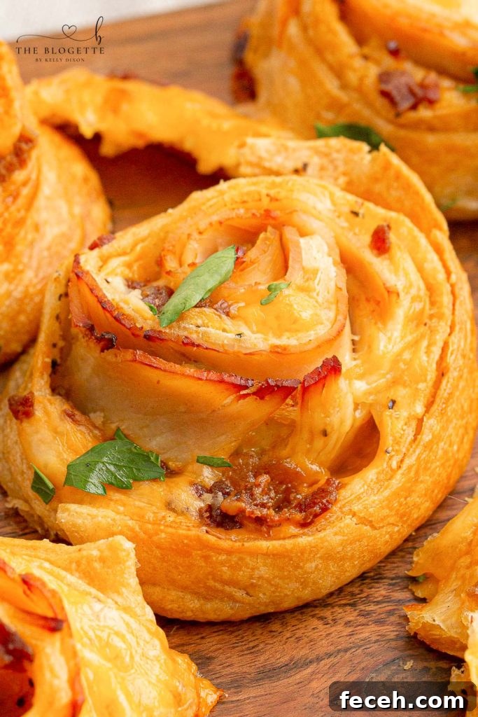 Baked Turkey and Cheese Rolls have melted cheese, bacon, and turkey covered in a garlic buttery glaze! The perfect party appetizer idea!