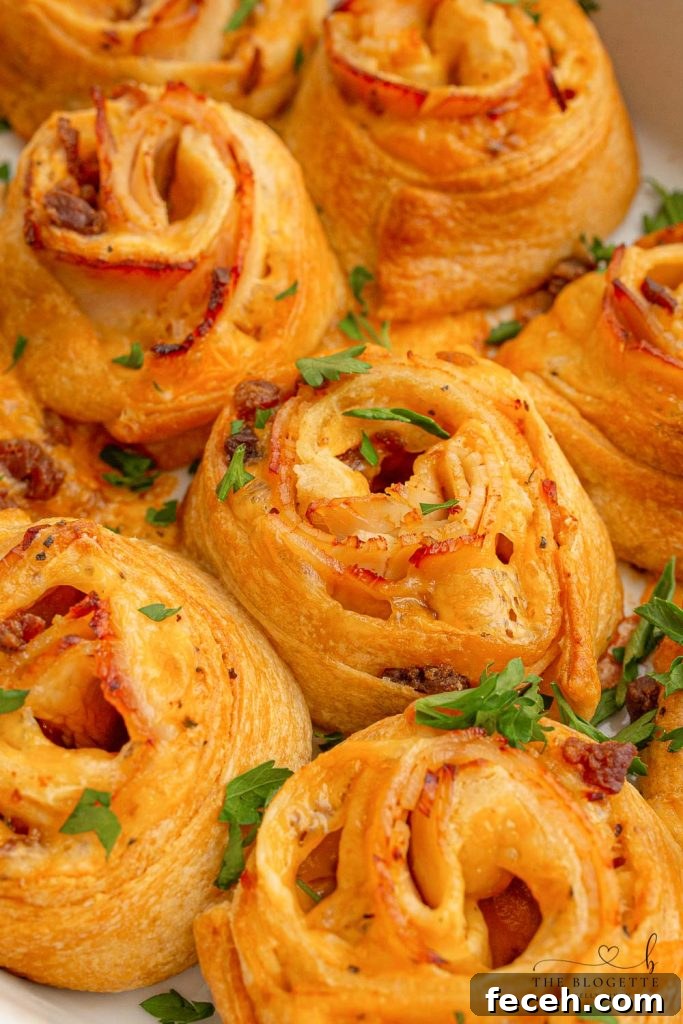 Baked Turkey and Cheese Rolls have melted cheese, bacon, and turkey covered in a garlic buttery glaze! The perfect party appetizer idea!