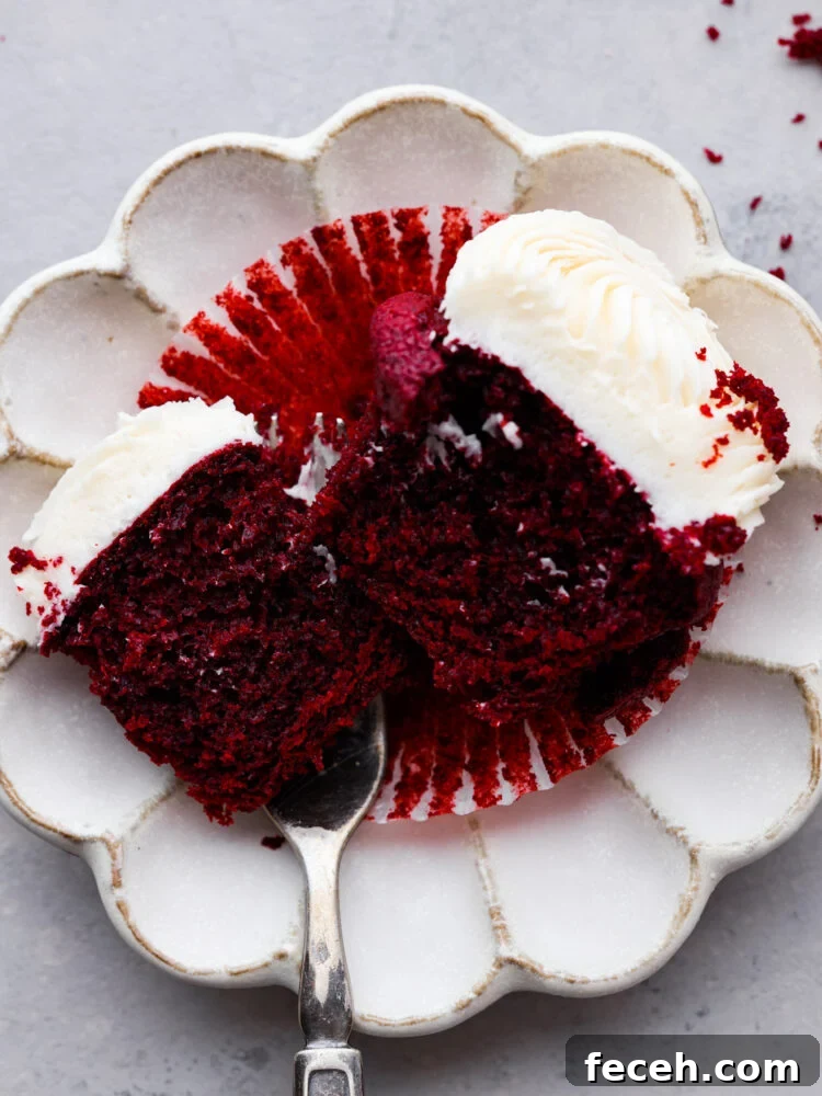 Cupcake cut in half. A cupcake cut in half and served on a white plate.