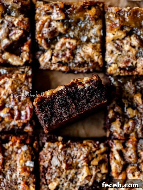 Homemade Baked Chocolate Donuts Recipe — Soft & Fudgy Treats 10 Salted pecan pie brownies placed on brown parchment paper with the center brownie placed on its side.