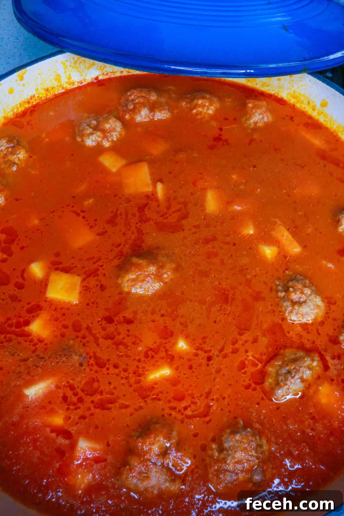 Pot with meatballs and potatoes in chipotle sauce