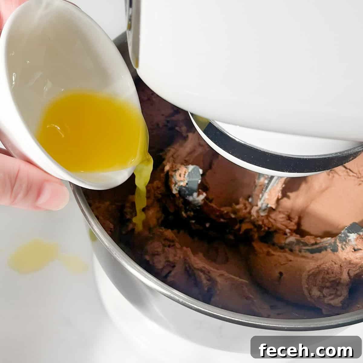 Thinning the buttercream with some orange juice.
