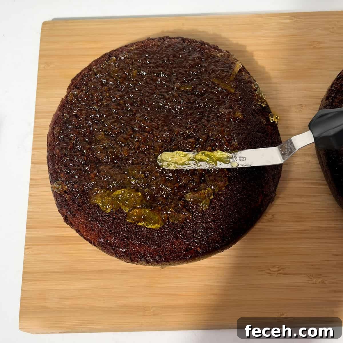 Spreading marmalade on the chocolate orange cake.