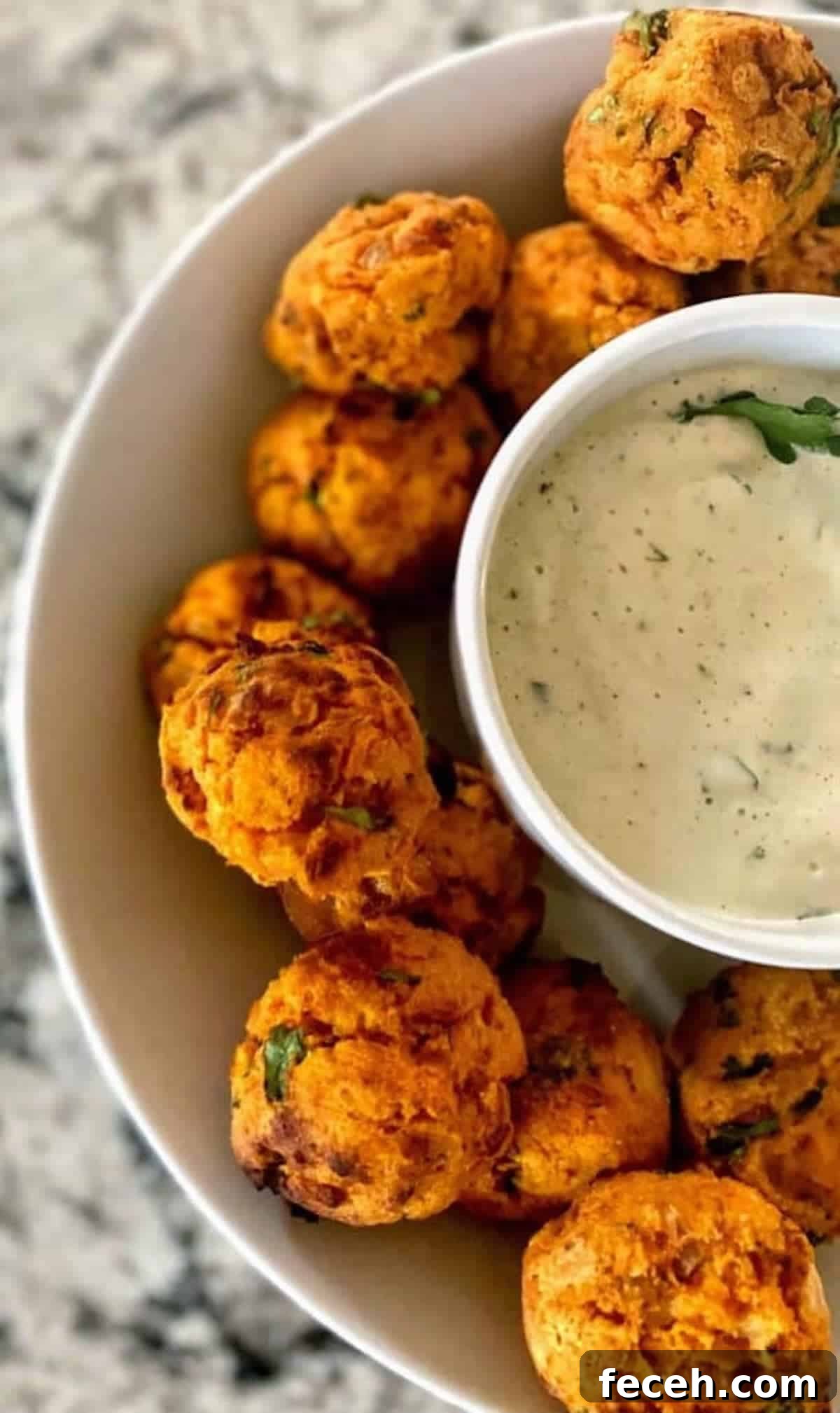 Sweet potato balls recipe in a bowl with ranch dressing