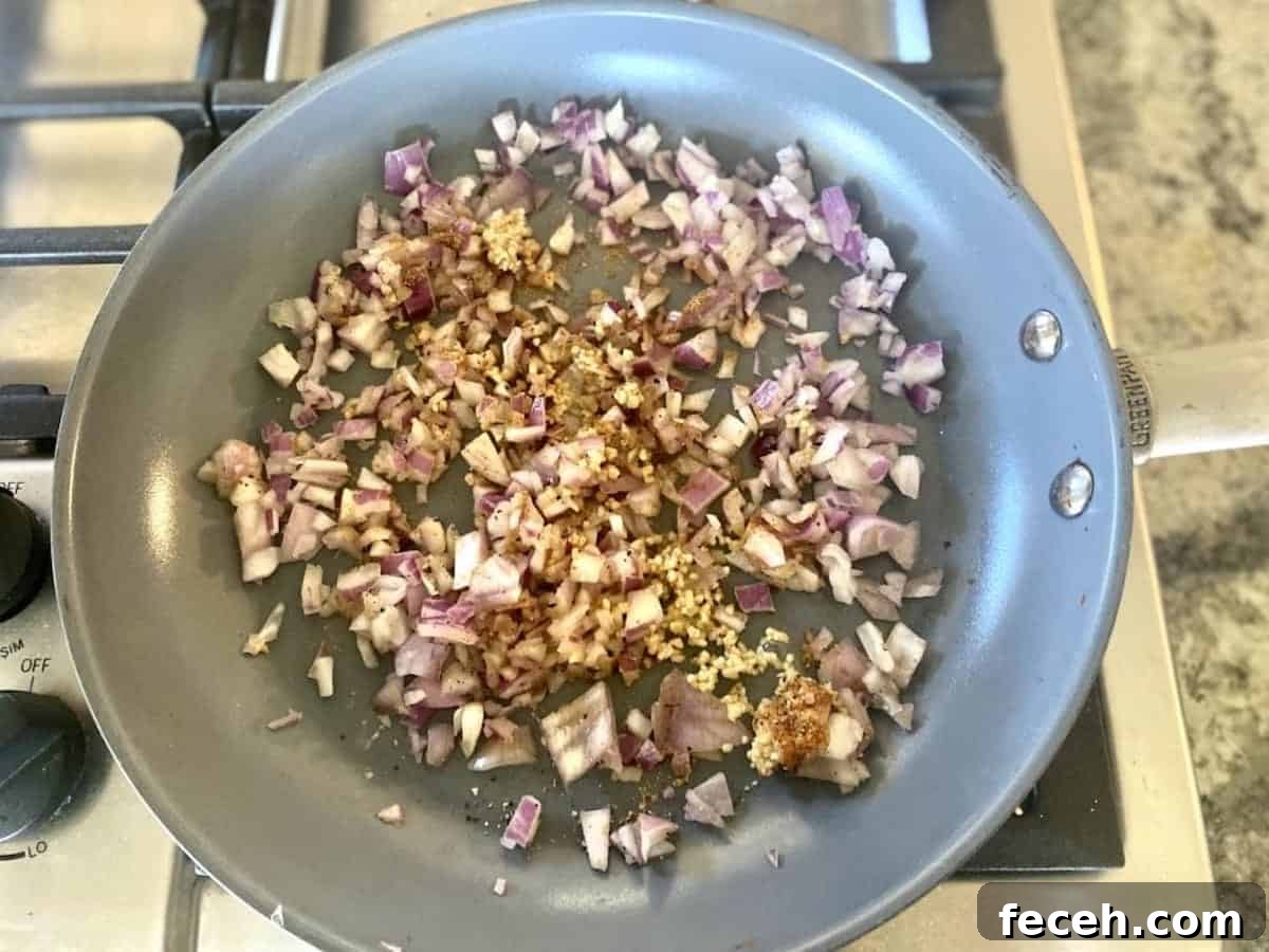 Sauteing shallots and garlic in a skillet on the stove
