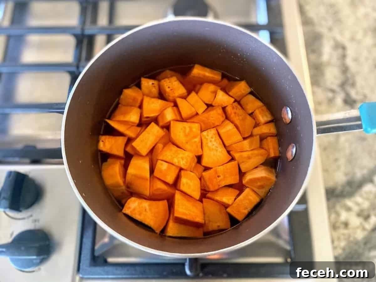 Sweet potatoes cooking in a pan on the stove