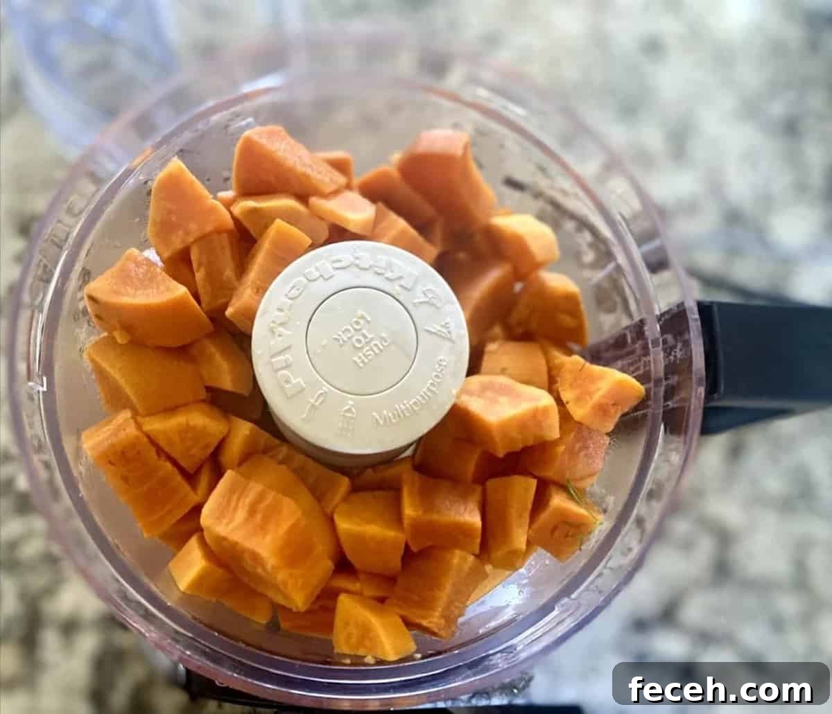 Sweet potatoes in a food processor bowl on the counter