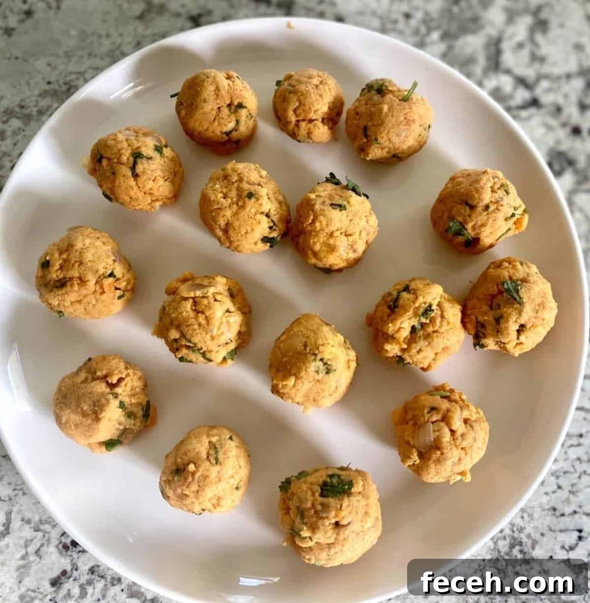 Sweet potato mixture formed into balls on a plate. 