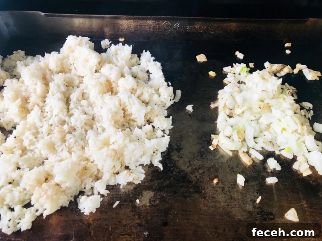 Hibachi-Style Shrimp Fried Rice Recipe for Flavorful Weeknights 4 rice and onions on flat top