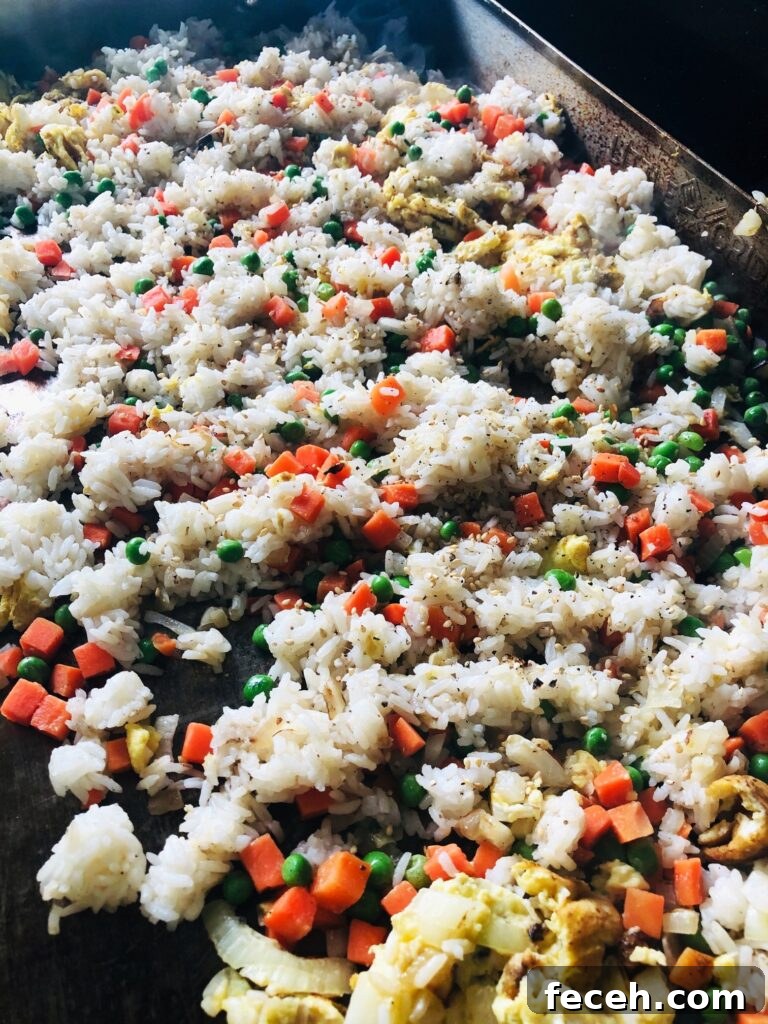 Hibachi-Style Shrimp Fried Rice Recipe for Flavorful Weeknights 5 rice and veggies on flat top