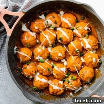 buffalo chicken meatballs in a pan with green onions