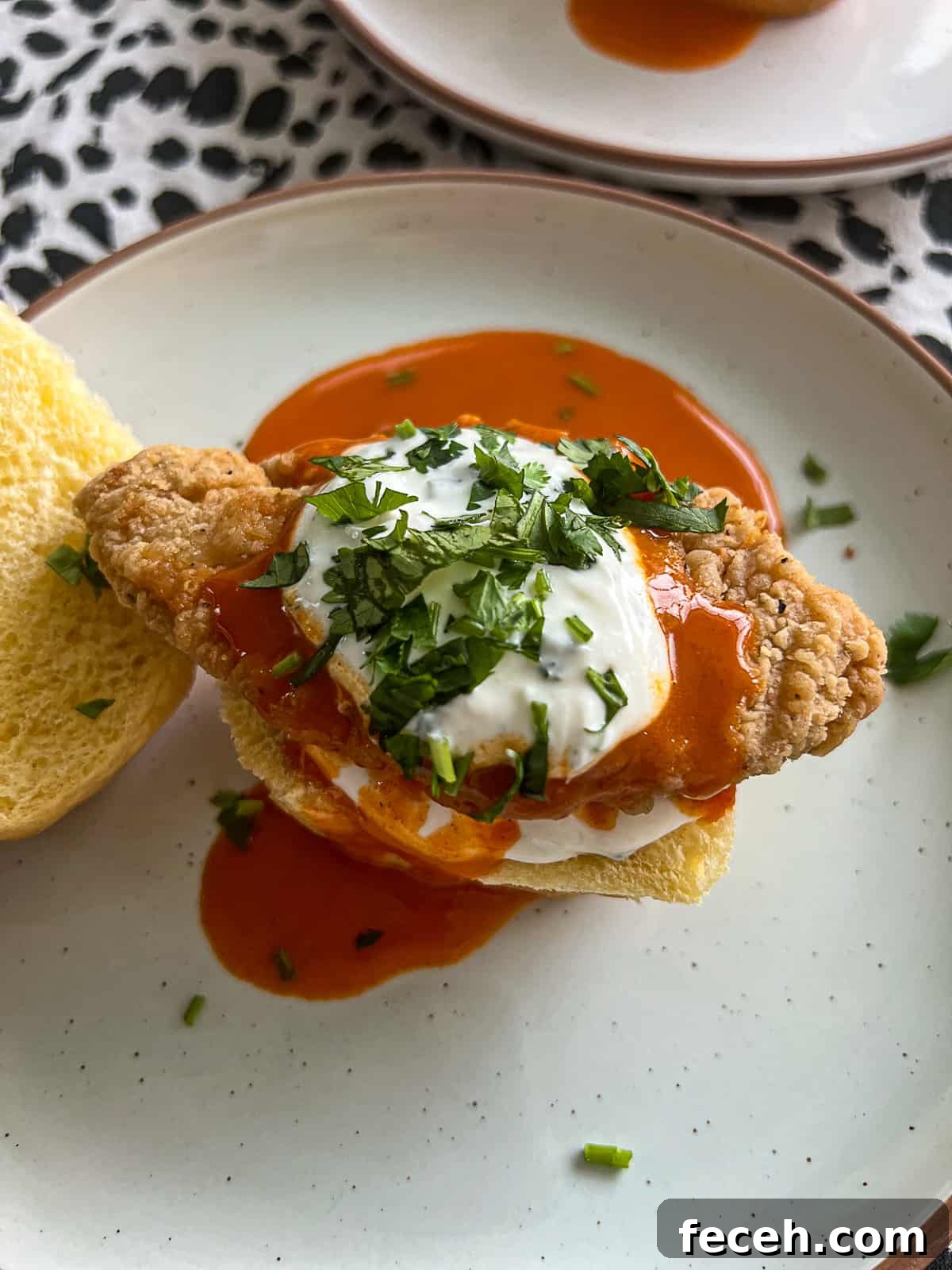 Closeup of game day appetizer chicken sliders with Buffalo Sauce and blue cheese