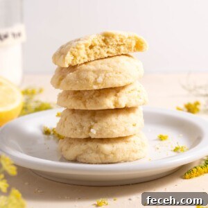 A stack of lemon and fennel pollen sugar cookies, surrounded by fennel flowers