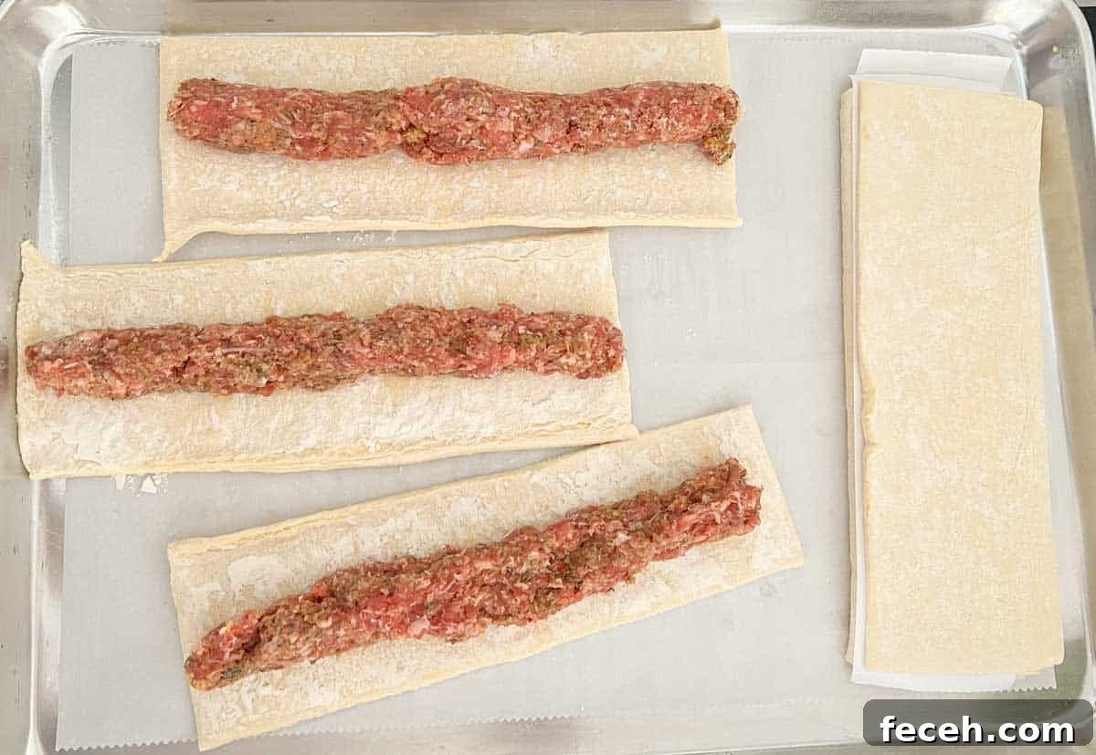 sauasge roll filling on unbaked puff pastry dough