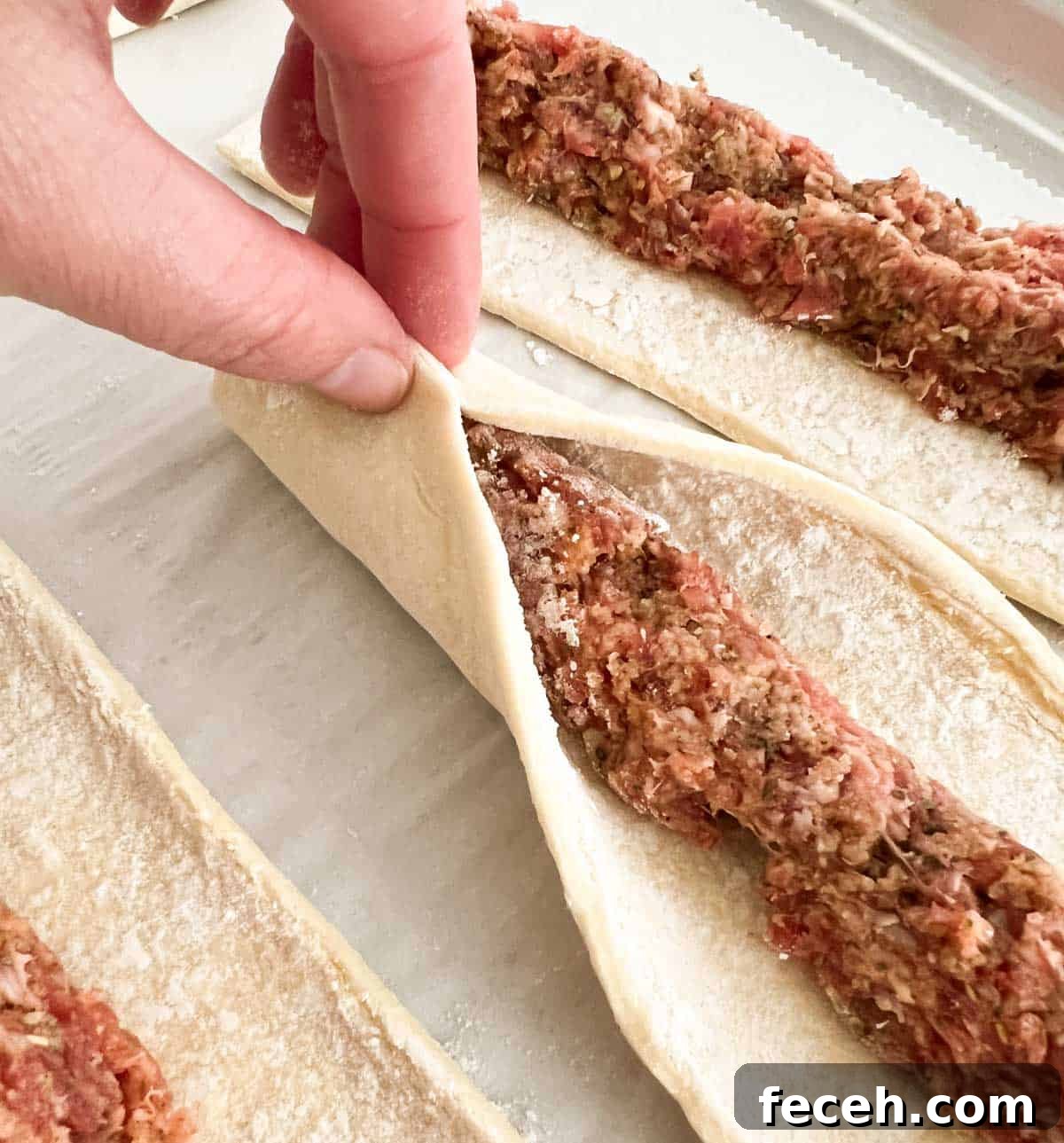 pinching sausage rolls closed