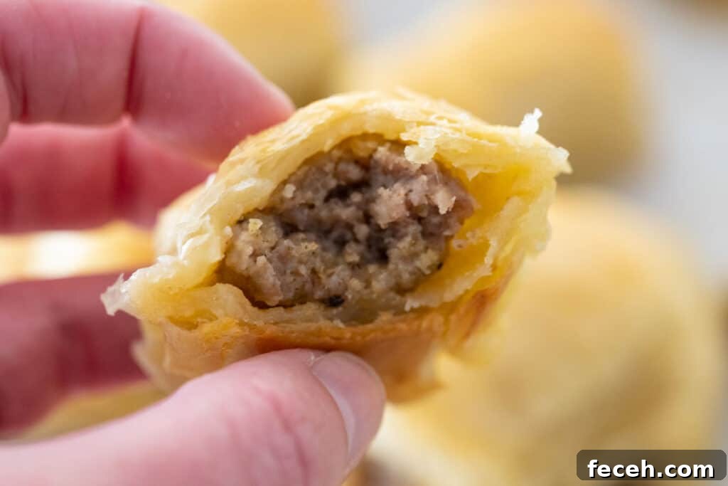 hand holding sausage roll