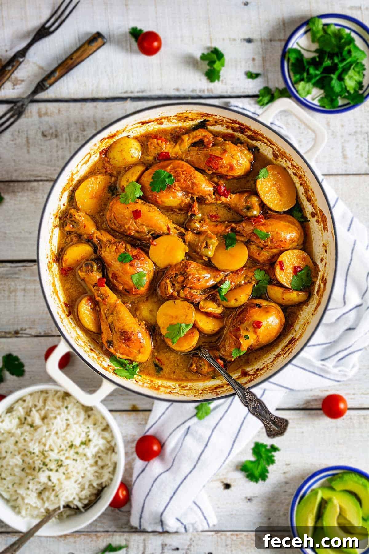 15 Global Soups and Hearty Stews to Warm Any Night 22 Colombian stew with chicken and potatoes in a Dutch oven on a white wooden table with other condiments.