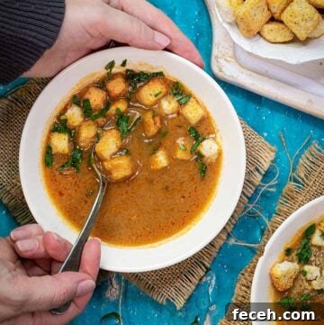 15 Global Soups and Hearty Stews to Warm Any Night 23 A person scooping up roux soup from a bowl with a spoon.