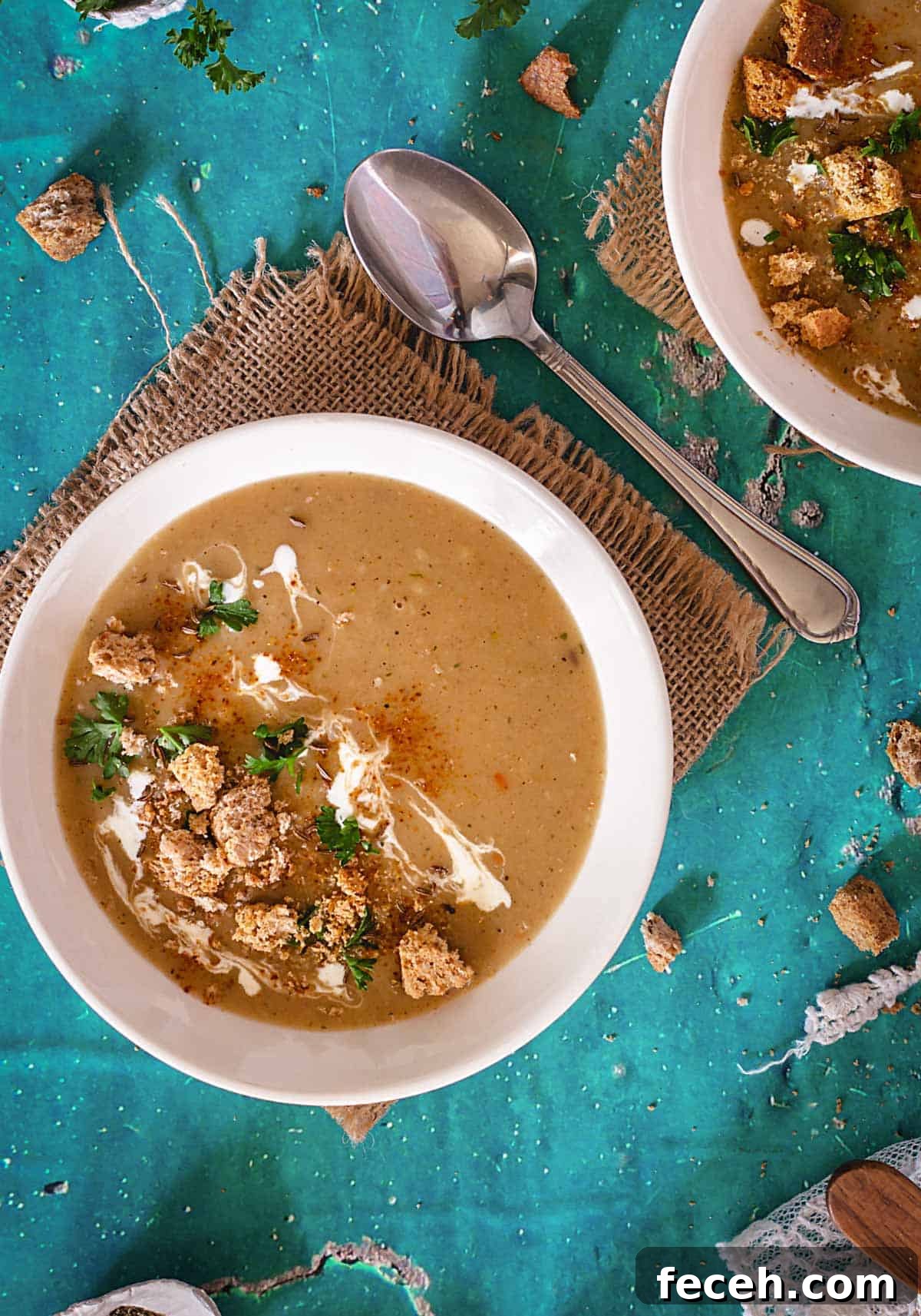 15 Global Soups and Hearty Stews to Warm Any Night 5 A bowl with browned flour soup, croutons, parsley, and sour cream.