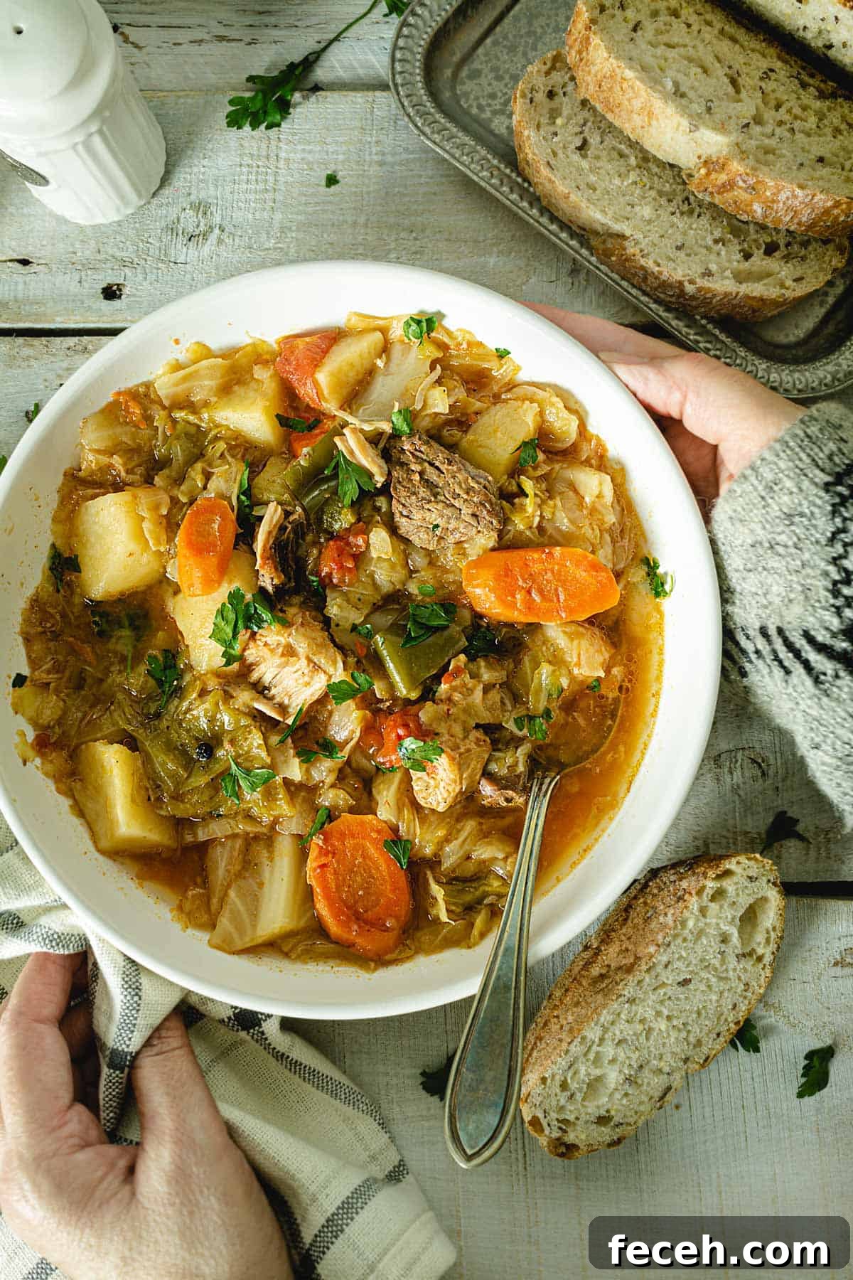 15 Global Soups and Hearty Stews to Warm Any Night 8 Placing a bowl of cabbage soup on a wooden table.