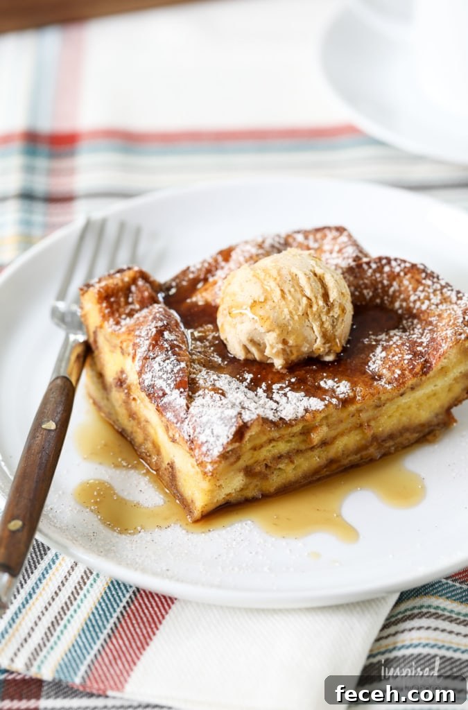 pumpkin french toast casserole topped with butter and maple syrup served on a plate with a fork.