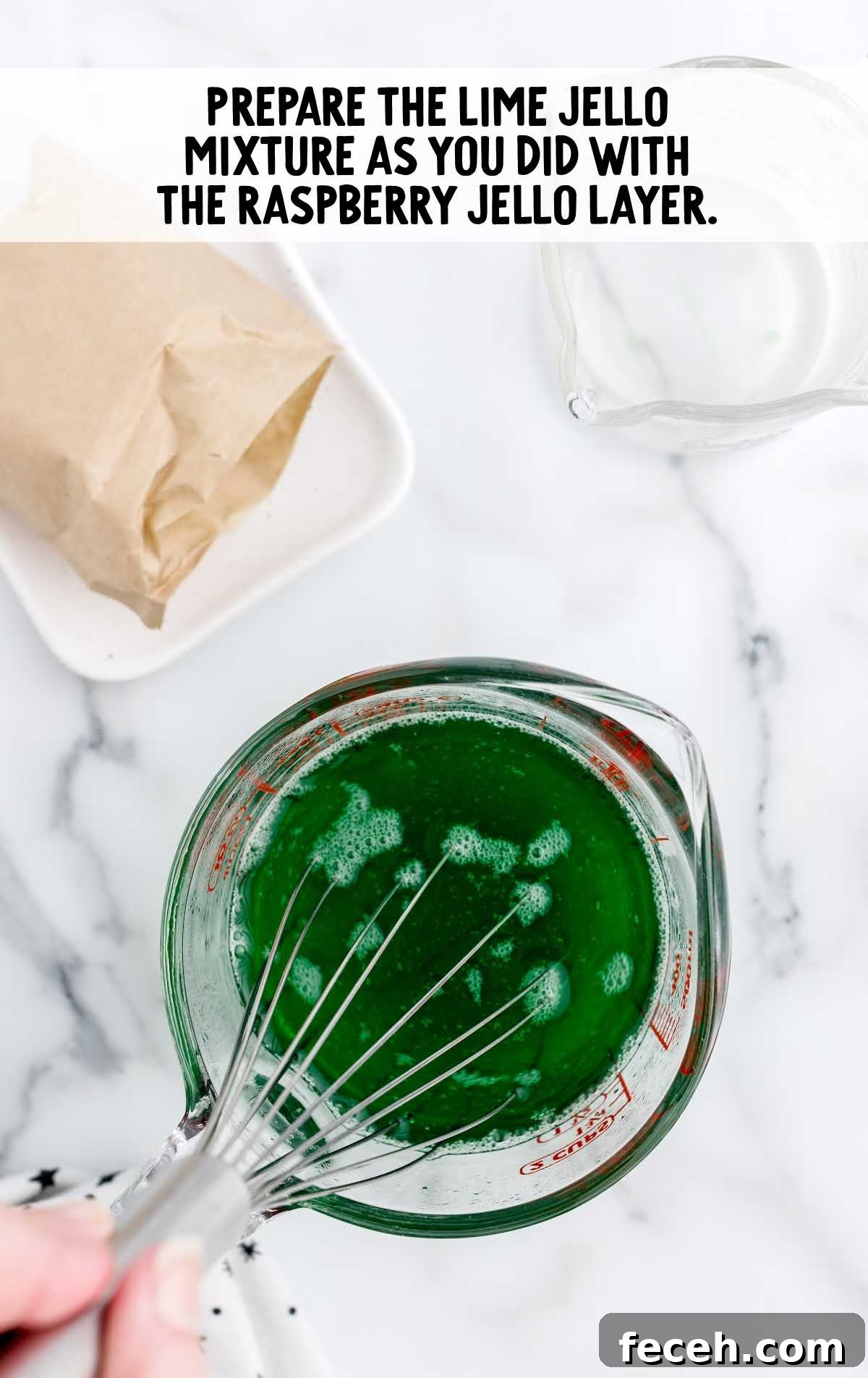 lime jello mixture whisked in a measuring cup
