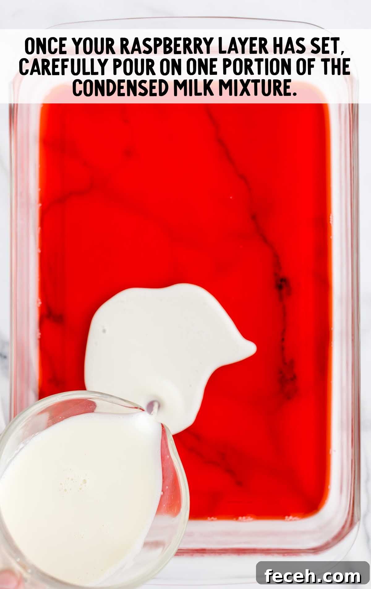 condensed milk mixture poured on the raspberry layer in a baking dish