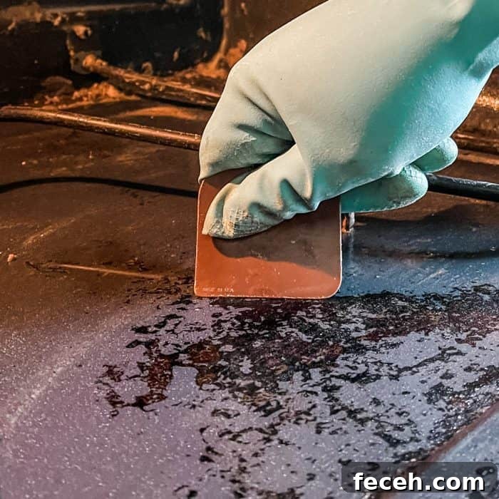 use a plastic scrapper (or razor blade) to scrape any stubborn bits of burnt on food from oven