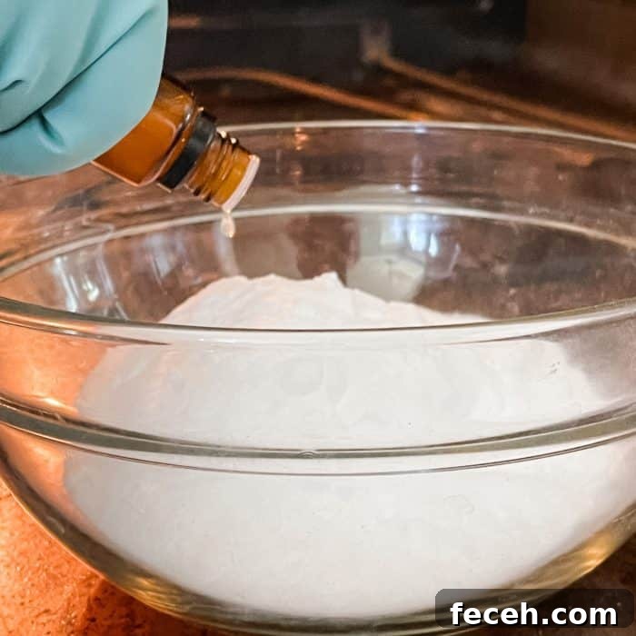 adding essential oil to baking soda for natural oven cleaner