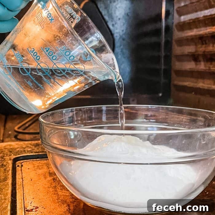 adding hot water to make cleaning paste