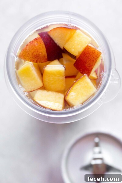 Homemade Peach Syrup Recipe for Cocktails, Pancakes & Desserts 5 Diced peaches in a mini blender.