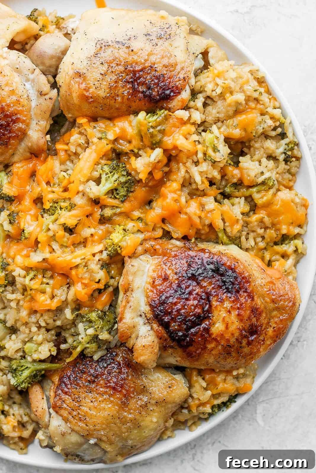 A plate of cheesy chicken broccoli and rice.