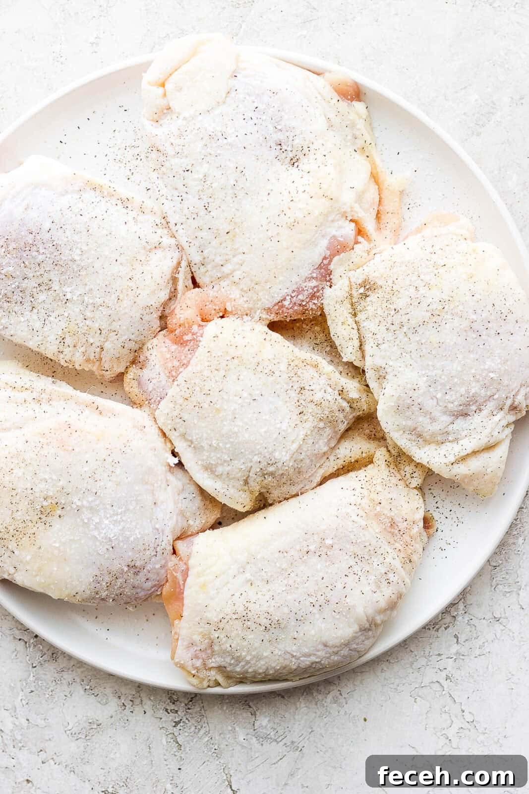 Chicken thighs seared with salt and pepper.