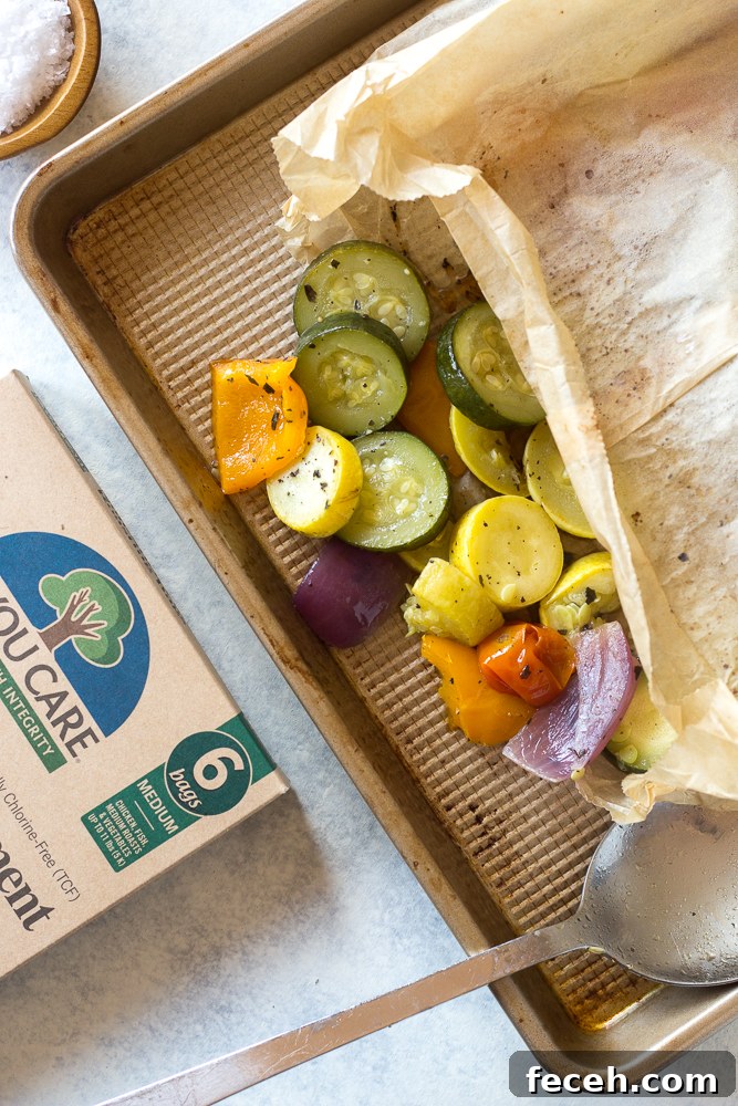 Oven Roasted Summer Vegetables in parchment paper roasting bag topped with fresh herbs