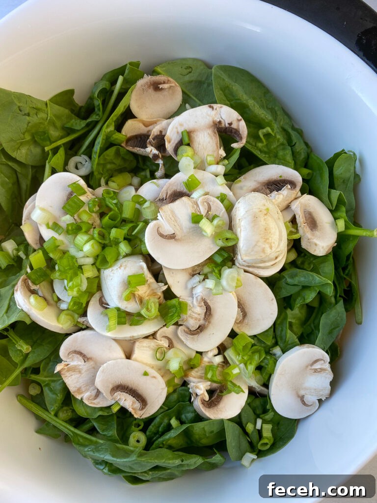 Spinach Salad with Bacon, Mushrooms, and Warm Balsamic Dressing 7 Green onions and fresh sliced mushrooms piled on top of baby spinach