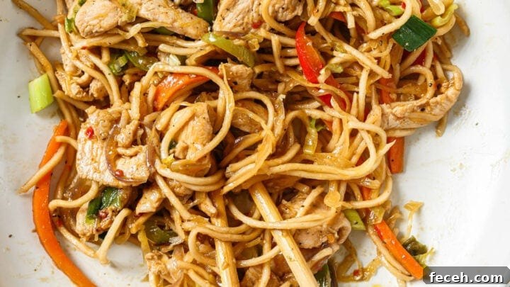 Top view of a bowl of Hakka Noodles with a pair of chopsticks.